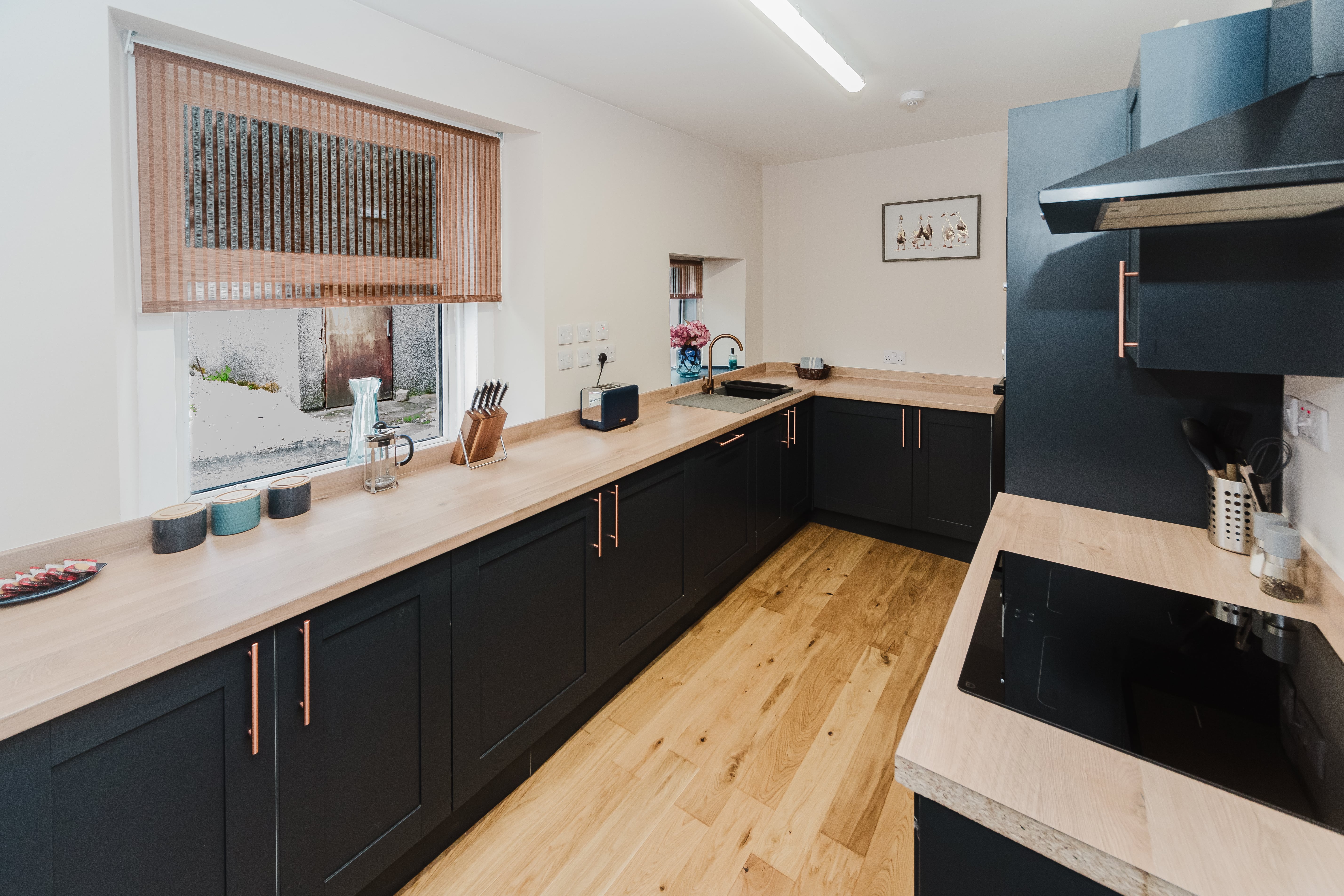 Fully equipped kitchen with navy cabinets